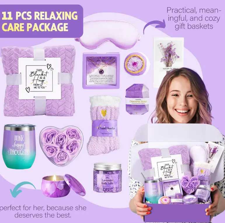 Lavender care package with a plush blanket, tumbler, candles and bath bombs next to a smiling woman